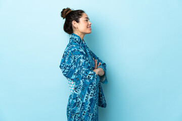 Woman wearing kimono over isolated background in lateral position