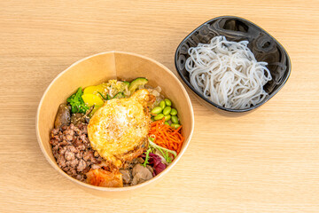 Korean Bibimbap Recipe in a Home Delivery Cardboard Bowl with Sweet Potato Noodles