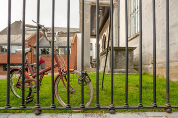 Fototapeta na wymiar brown makeup colour bike hooked to a metal fence
