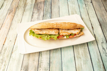Great sandwich of fried chicken breast fillets on lettuce and tomato with mayonnaise
