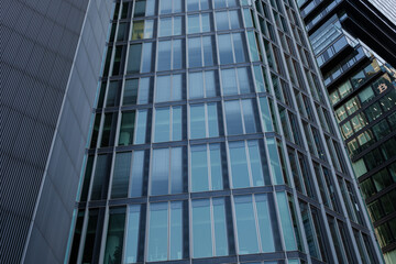 Fototapeta na wymiar Exterior architectural detail modern facade of High-rise office buildings. Abstract Urban metropolis background.