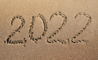 2022 inscription on the sand