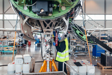 Maintenance of airplane in the large white hangar