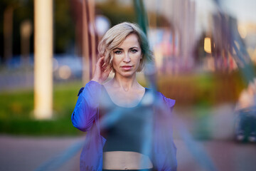 Graceful woman stands on playground after exercises.