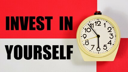 Invest in yourself. The inscription on the background of the clock. placement of capital for the purpose of obtaining financial profit or knowledge in education.