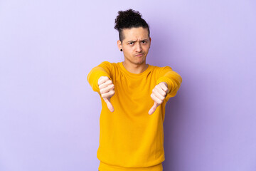 Caucasian man over isolated background showing thumb down with two hands