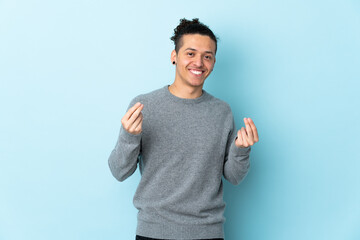 Fototapeta premium Caucasian man over isolated background making money gesture