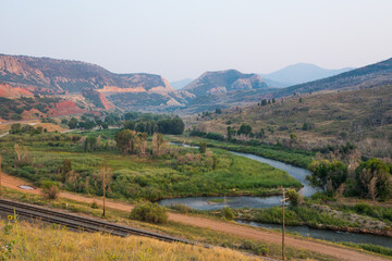 Fototapeta premium Beautiful landscape with a mountain range, river and country road. Location is Utah, USA