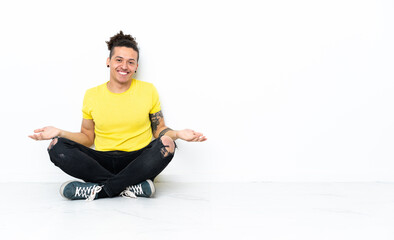 Caucasian man sitting on the floor smiling