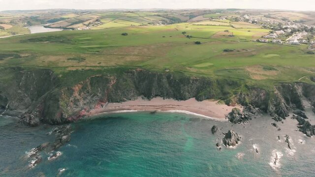 Aerial drone shot of beautiful coast and sandy cove in South Devon, UK