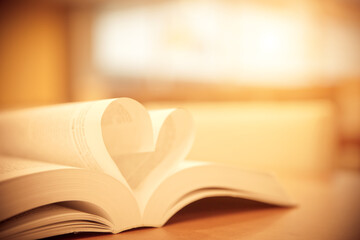 Book heart and valentine, close up page of book in heart shape at library of love to read and...