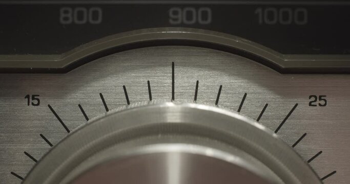 Volume Knob Dials. Macro extreme close up on a vintage silver brushed metal stereo system as the volume is adjusted up and down.