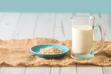Fresh organic milk  in glass jar and oatmeal
