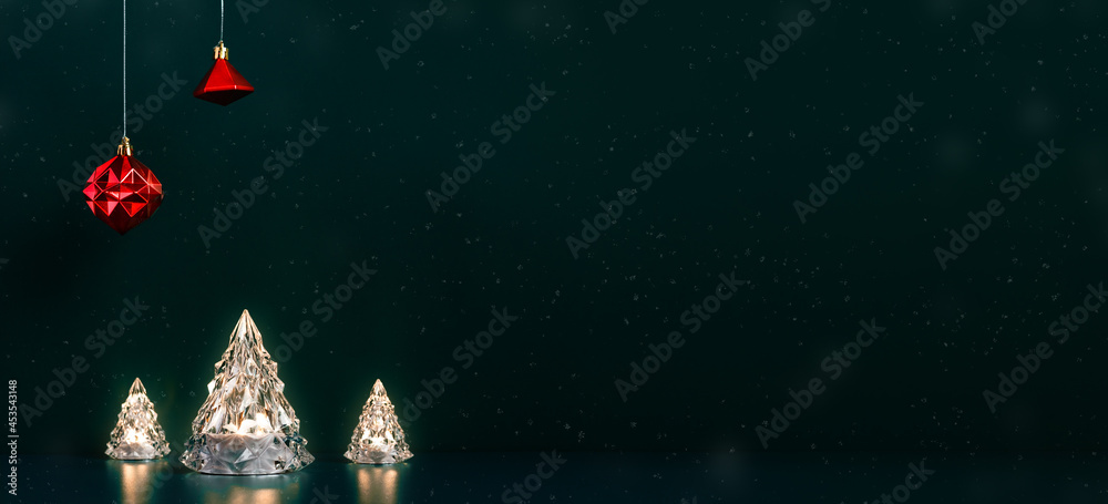 Poster merry christmas tree glowing lamp lights with red baubles hanging on dark blue green background with
