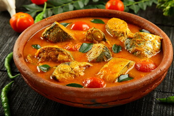 Homemade delicious Kerala fish curry with coconut milk and green mangoes. cooked in clay pottery.
