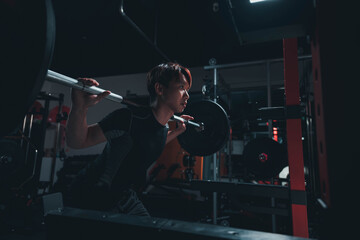 man doing squat in the gym