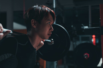 man doing squat in the gym