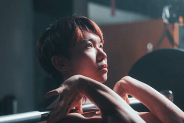 man doing front squat in gym