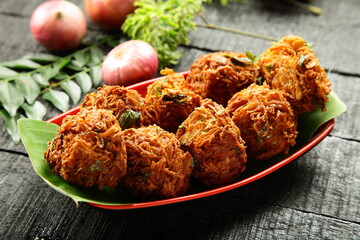 Homemade delicious onion fritters, ulli vada, south Indian street food recipes.