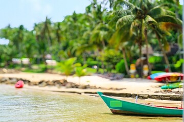 Small fishing boats moored ashore with coconut palms lined the sandy beach at Hua Hin Sea, Thailand is a popular tourist destination where tourists come to relax and relax.