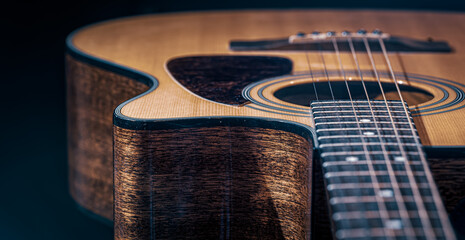 Close-up of a classical acoustic guitar with wooden texture. - obrazy, fototapety, plakaty