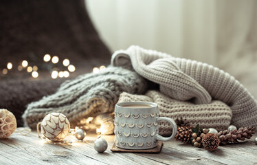 Cozy winter composition with a cup and decor details.