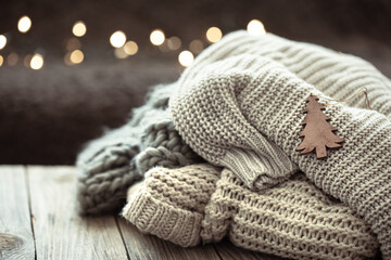 Fototapeta na wymiar Winter festive background with knitted element on blurred background.