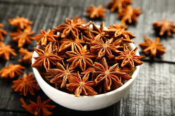 Fresh organic star anise spices served in  a ceramic bowl.