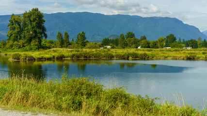 Serene Fraser Valley river scene, showing Alouette River with mountain backdrop
