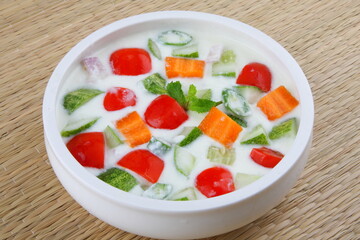 Homemade delicious appetizer vegetarian meal- healthy cucumber salad with curd. Indian vegan diet foods-