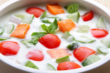 Homemade delicious appetizer vegetarian meal- healthy cucumber salad with curd. Indian vegan diet foods-