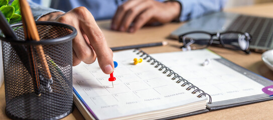 Businessman agenda calendar and reminder agenda work online at home men plan daily appointments and vacation travel journals in a diary at their desk . calendar reminder event concept .