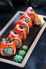 California rolls with shrimp. Traditional Japanese food. Rolls with shrimp, tobiko caviar and cucumber.Healthy food. Restaurant menu concept.Vertical photo.Top view.Out of focus.