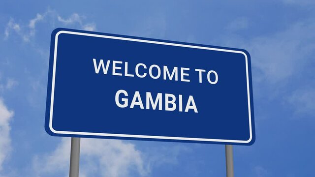 Welcome to Gambia Road Sign on Clear Blue Sky with Rapid Moving Clouds