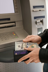 Man withdrawing money from ATM, closeup