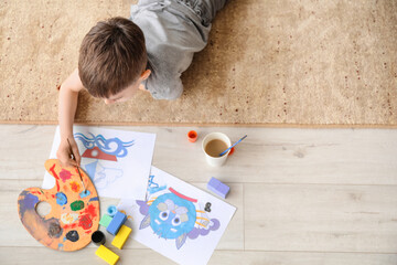 Little boy painting at home