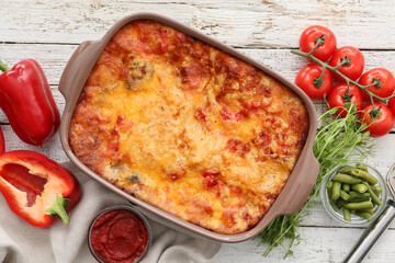 Composition with tasty vegetable lasagna on light wooden background
