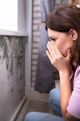 Shocked Woman Looking At Mold On Wall - obrazy, fototapety, plakaty