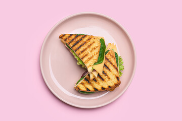 Plate with tasty sandwiches on color background