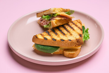 Plate with tasty sandwiches on color background, closeup