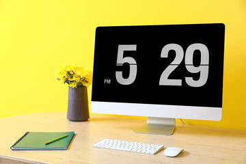 Modern workplace with computer near color wall