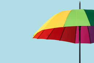 Stylish umbrella on light background