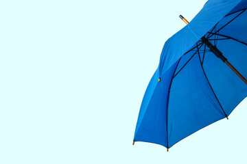 Stylish umbrella on light background