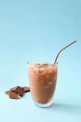 Glass of tasty chocolate milk on color background