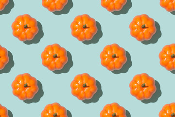 Top view photo of orange pumpkins on isolated pastel blue background