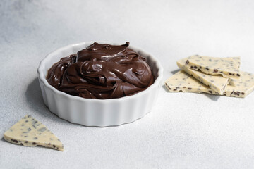 Cocoa spread food photo. Brown chocolate paste with white chocolate pieces on white background.