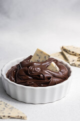 Cocoa spread food photo. Brown chocolate paste with white chocolate pieces on white background.