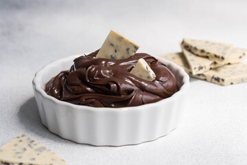 Cocoa spread food photo. Brown chocolate paste with white chocolate pieces on white background.