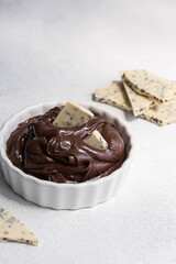 Cocoa spread food photo. Brown chocolate paste with white chocolate pieces on white background.