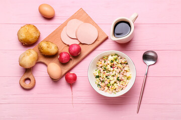 Bowl with different ingredients for okroshka on color wooden background